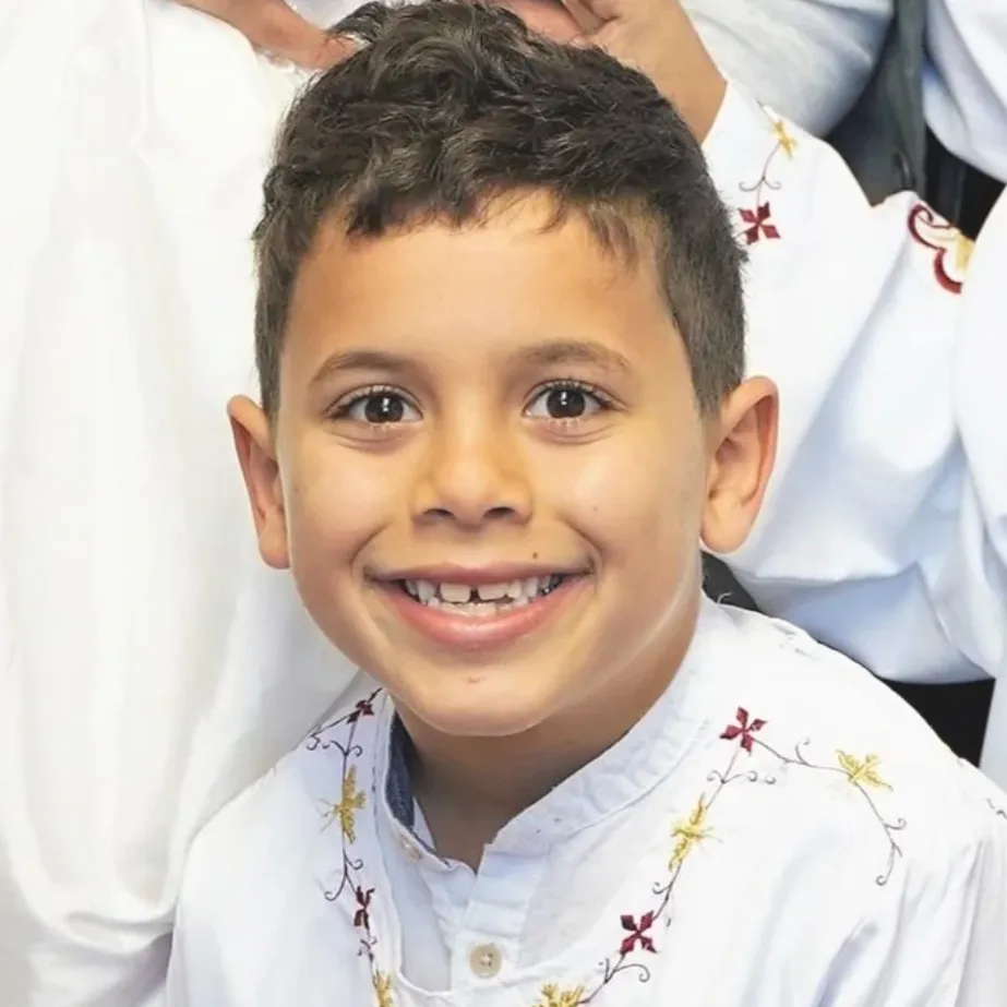 Jacob Iskander, an 8-year-old boy, smiling.