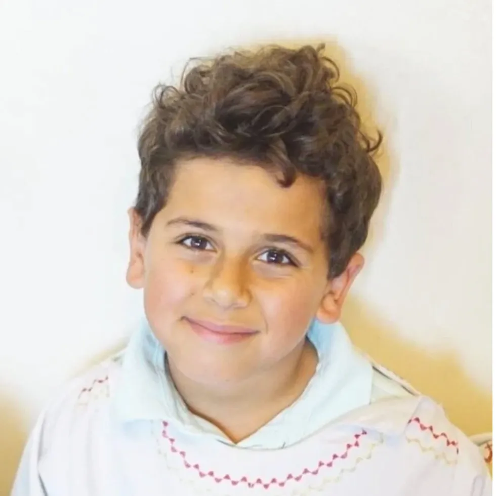 Mark Iskander, 11, smiling.