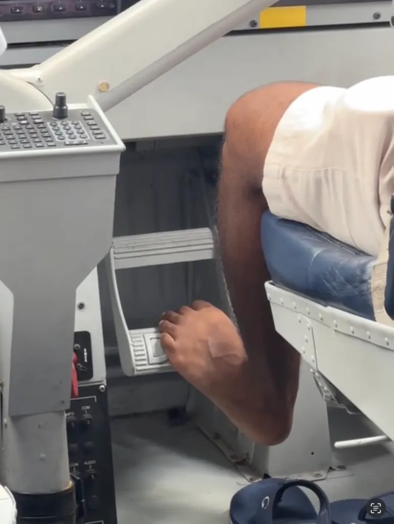 A pilot operating airplane pedals barefoot.