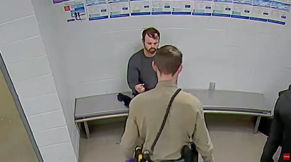 Joseph Duggar speaking with an officer.