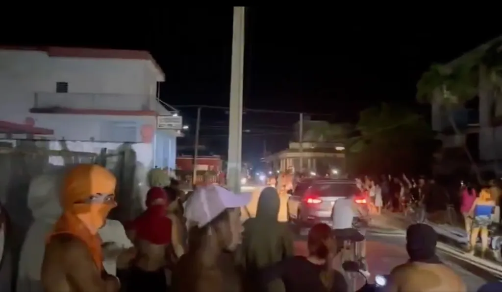 Protesters on the streets of Cuba at night.