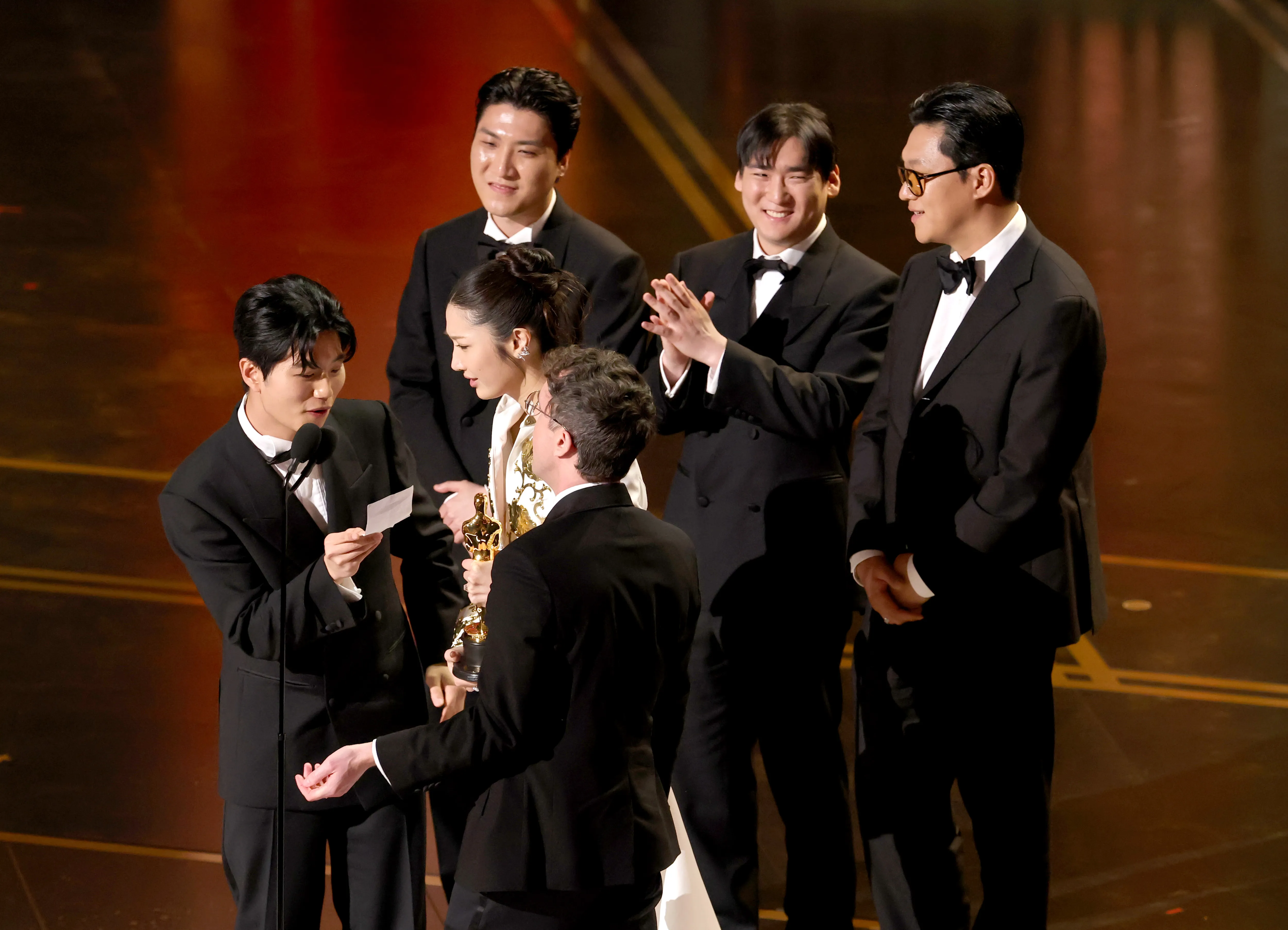 Six people accepting the Original Song award for