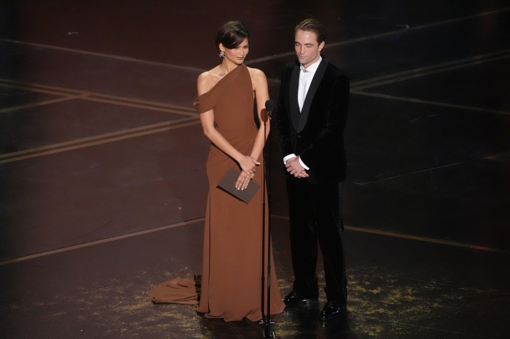Zendaya and Robert Pattinson presenting an award during the Oscars.