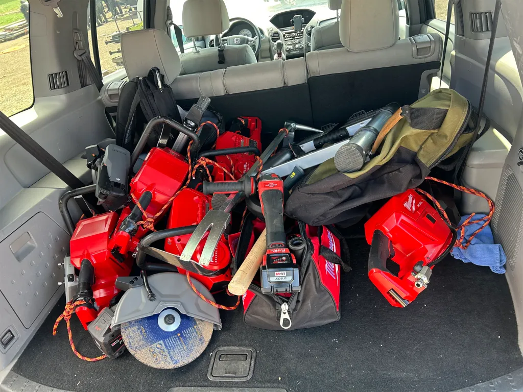 Rear view of a car filled with red power tools.