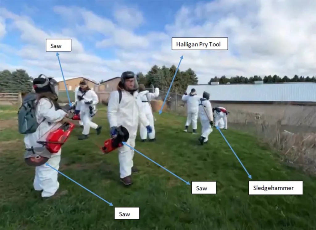 Animal rights activists wearing white hazmat suits and carrying tools like saws, a Halligan pry tool, and a sledgehammer.
