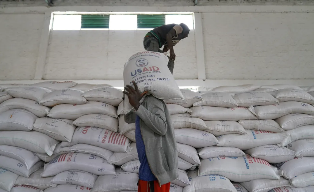 Aid workers distributing yellow lentils at an aid operation in Mekele, Ethiopia.
