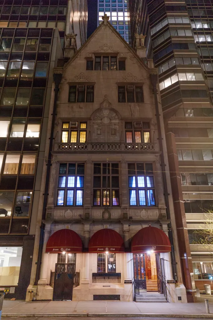 The Friars Club building at 57 East 55th Street in New York City at night.