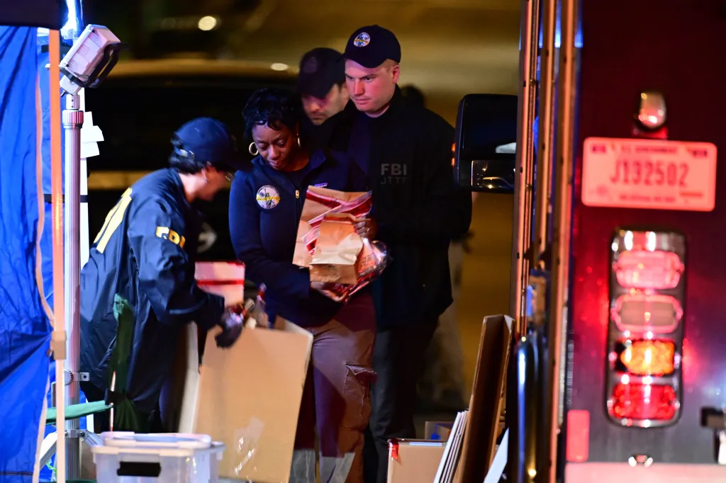 FBI agents collecting evidence during a raid.
