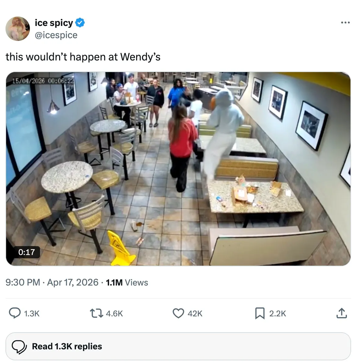 Ice Spice's tweet shows CCTV footage of a person in a white hoodie jumping over a table in a messy fast-food restaurant.