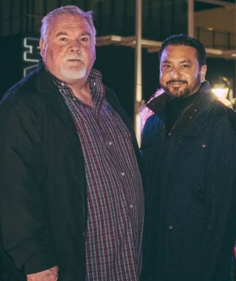 Two men standing next to each other, with Raj Malhi on the right.