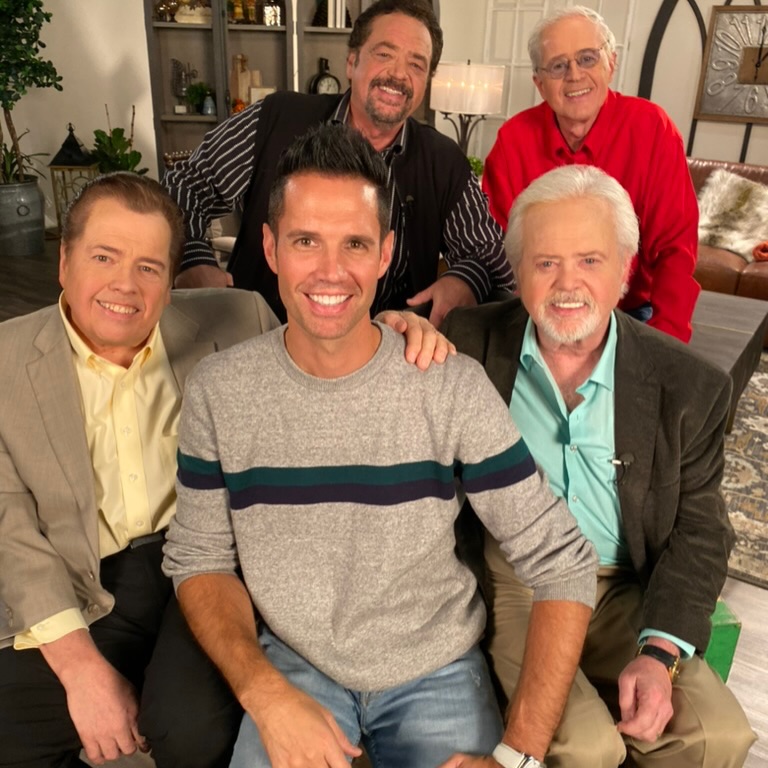 Alan and his family members smiling for a photo.