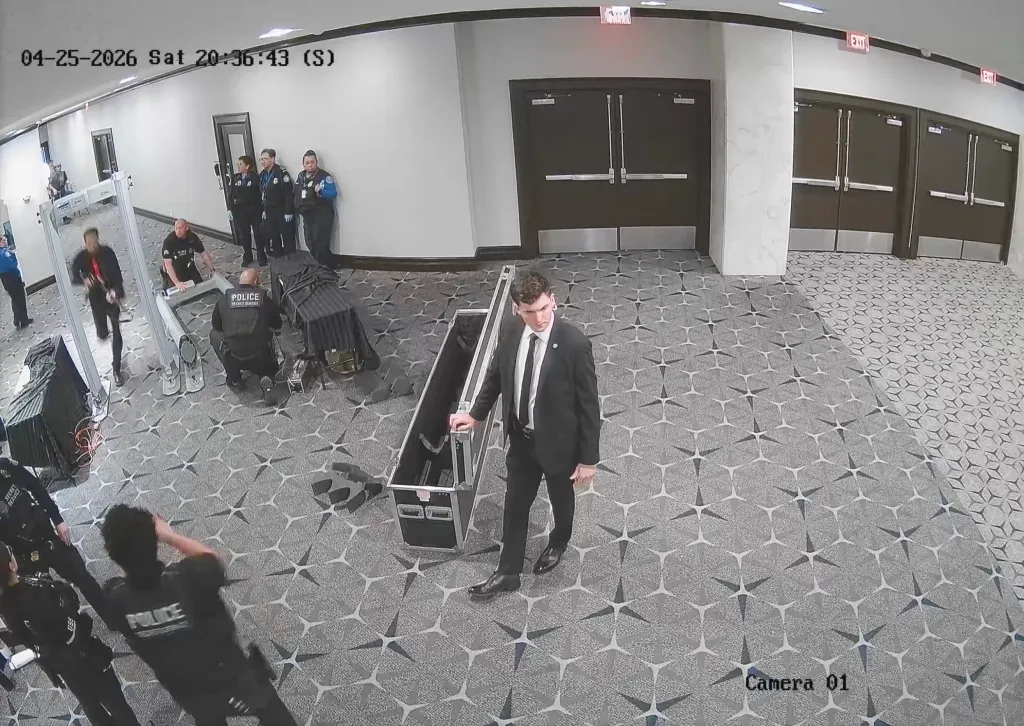 Security footage shows Secret Service personnel and police setting up security checkpoints and equipment in a large hall with patterned carpet.