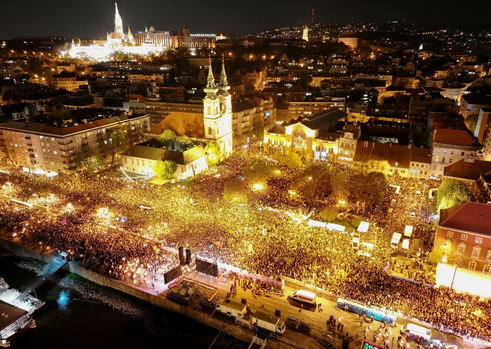 A drone view shows people gathering to celebrate across the Danube river from the Parliament building.