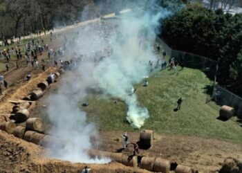 About 1,000 animal welfare activists tried to storm a beagle research facility protected by a manure-filled trench, hay bales and a barbed-wire fence