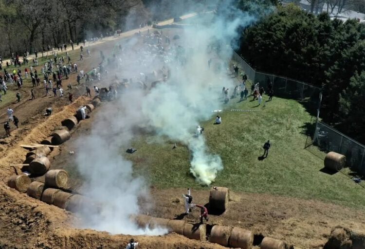 About 1,000 animal welfare activists tried to storm a beagle research facility protected by a manure-filled trench, hay bales and a barbed-wire fence