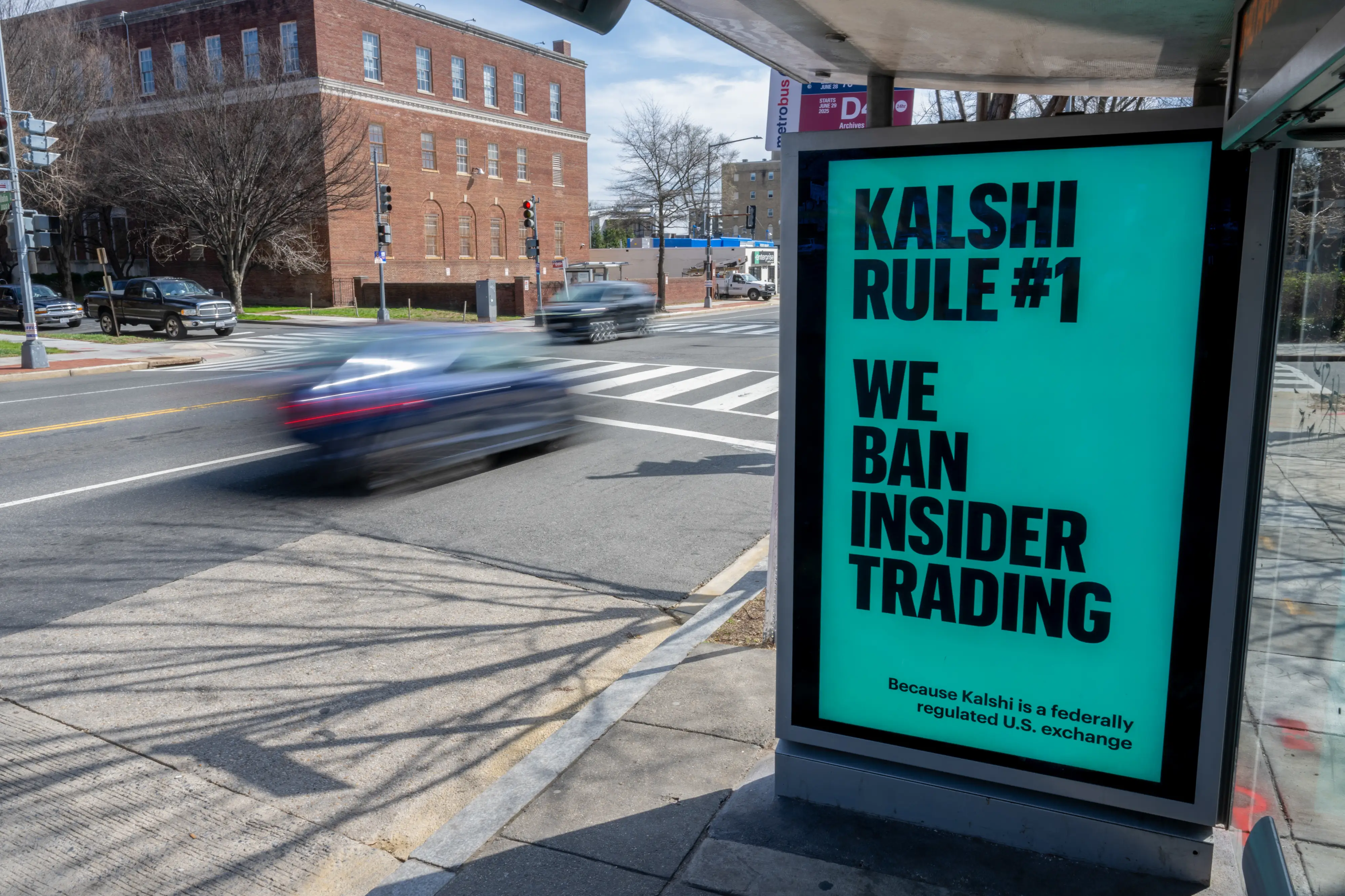 A Kalshi advertisement on a bus shelter