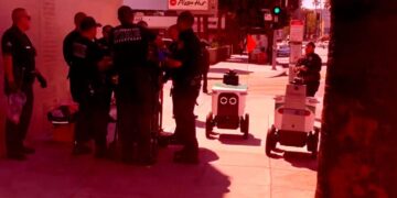 Two Delivery Bots Blunder Into the Middle of a Police Incident, Have Awkward Standoff