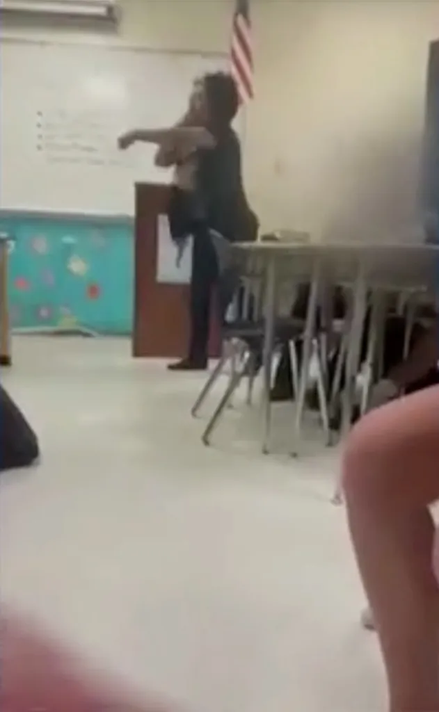 Substitute teacher allegedly grabbing a student by the neck.