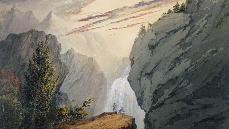 Two small people in front of a waterfall