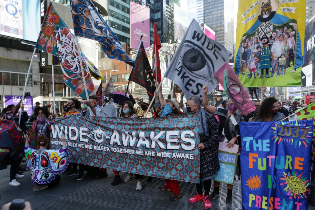 Attendees at the Wide Awakes Grand Procession in New York City holding banners and flags.