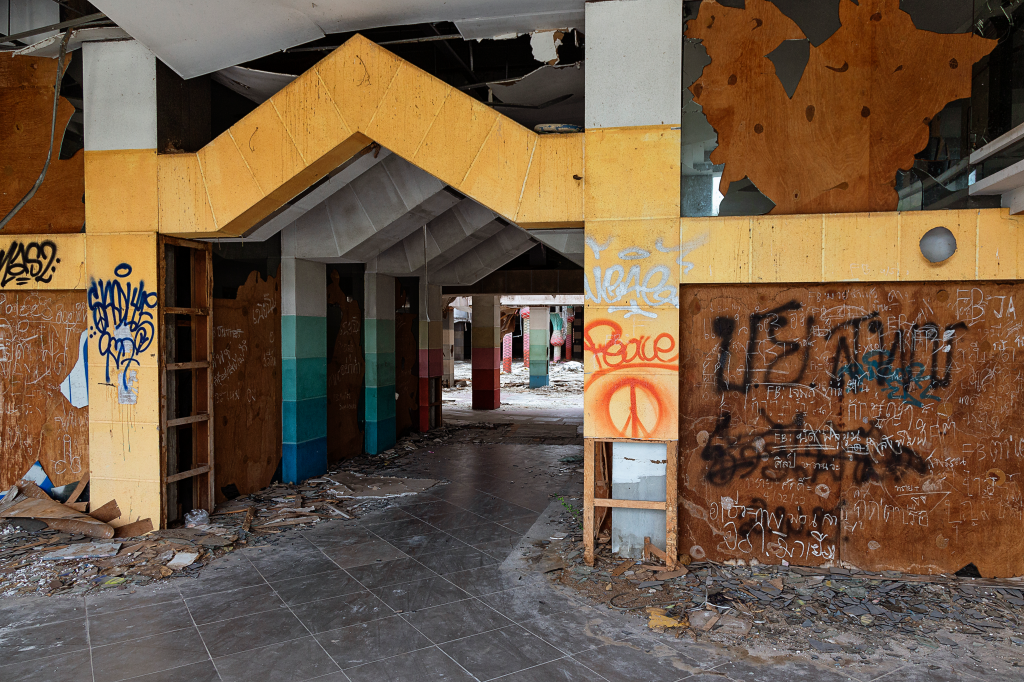 An abandoned structure in the Castle Mall in Thailand, covered in graffiti and debris, photographed in 2018.