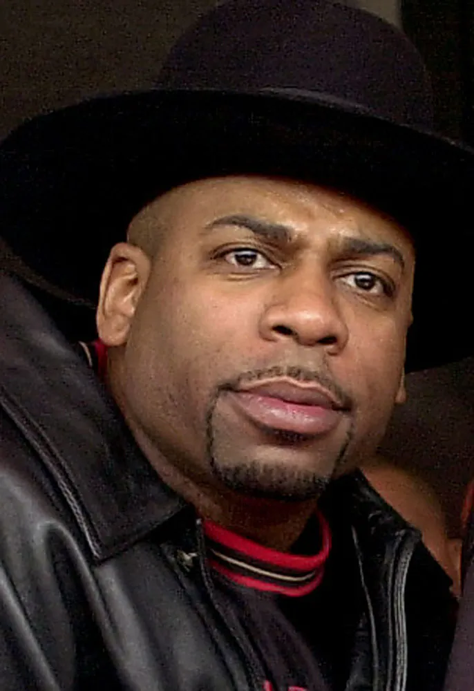 Headshot of Jam Master Jay, Jason Mizell, wearing a black hat and leather jacket.