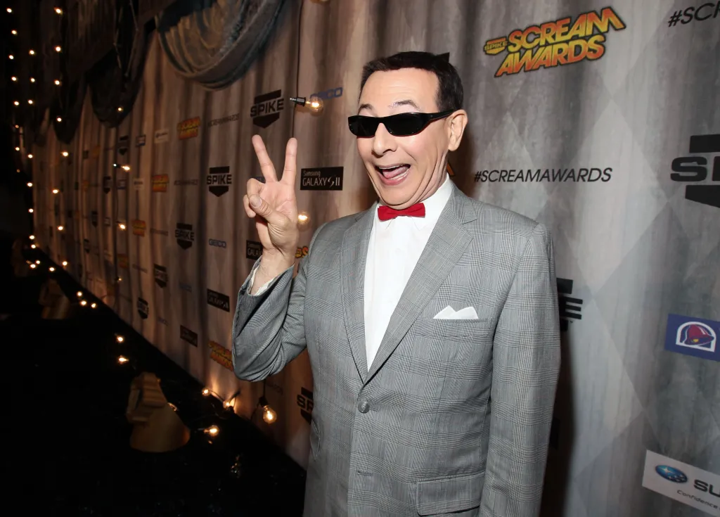 Paul Reubens, as Pee-wee Herman, making a peace sign on the red carpet at the Spike TV Scream 2011 awards.