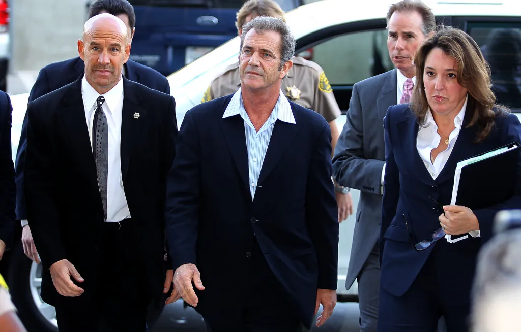 Mel Gibson (center) entering the Los Angeles Courthouse with two men and one woman.