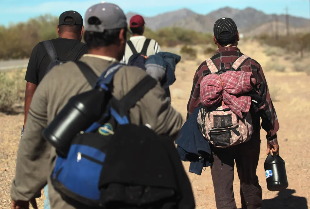 Illegal immigrants walk across the Sonoran Desert after sneaking across the US-Mexico border on Jan. 19, 2011.