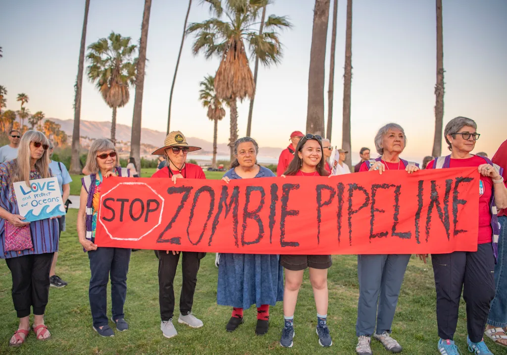 People protesting the Sable Oil Pipeline with a red banner that reads 