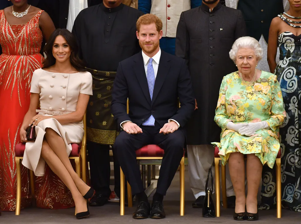 Meghan Markle, Prince Harry, and Queen Elizabeth II sit in the front row at the Queen's Young Leaders Awards Ceremony.