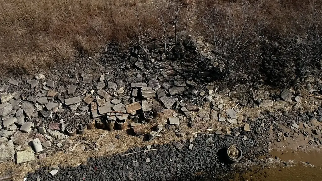 Debris, including rocks, trash, and rubble, along the Keyport bayshore near the Aeromarine Industrial Park.