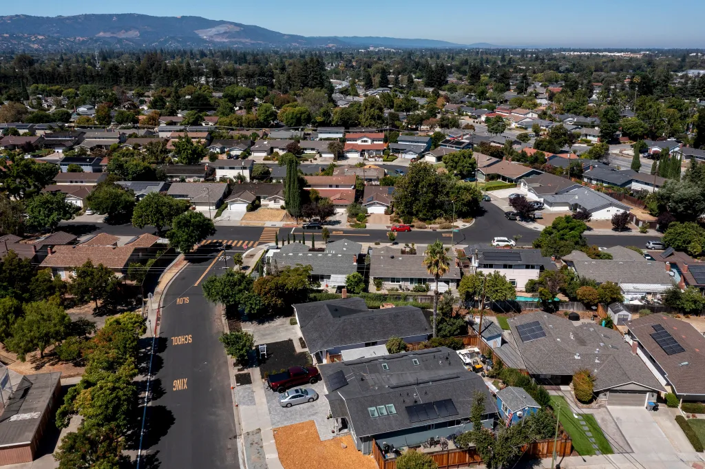 Aerial view of a residential neighborhood in San Jose, California, with houses, trees, and roads.