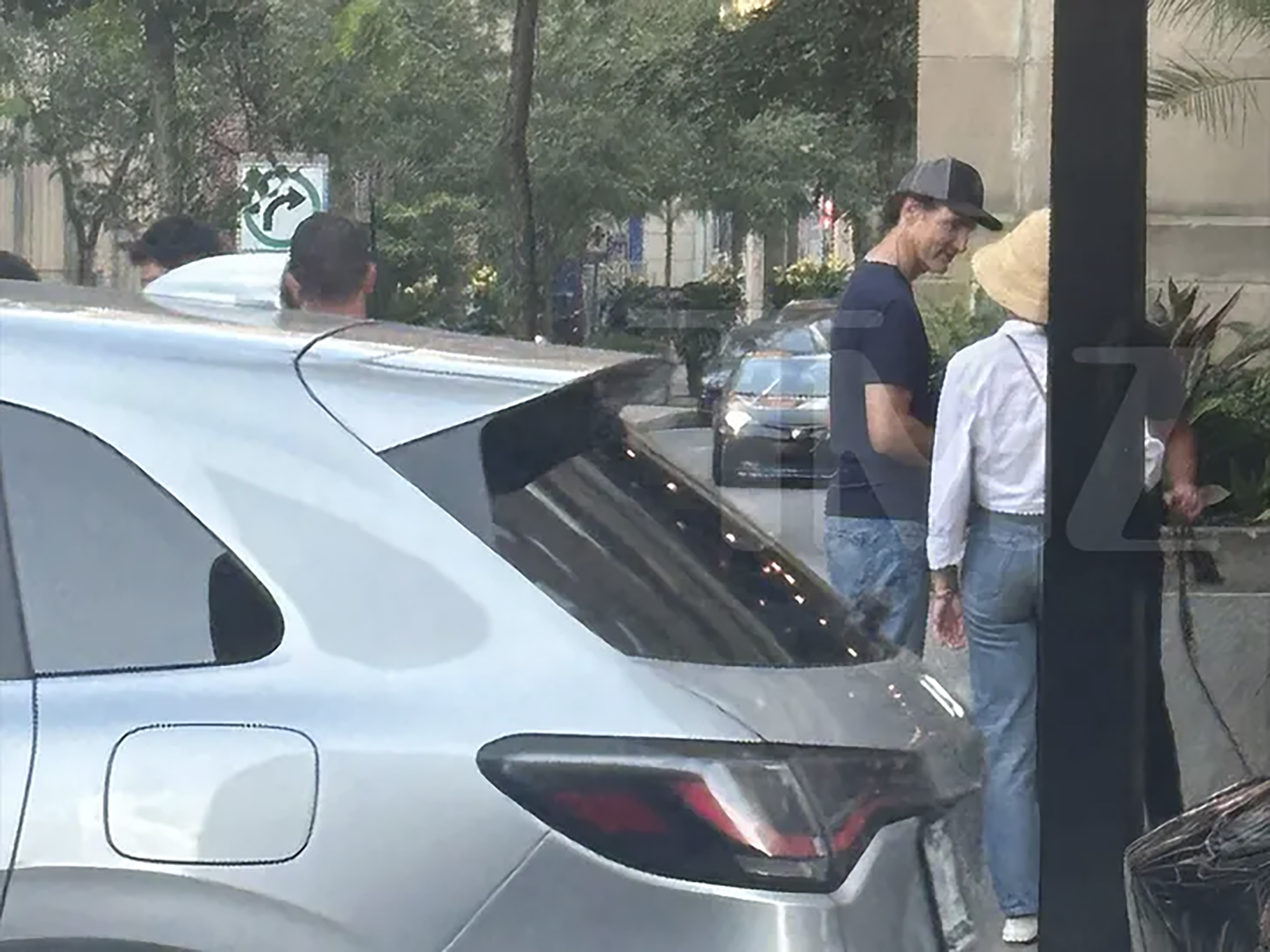 Justin Trudeau and Katy Perry walking together on a street.