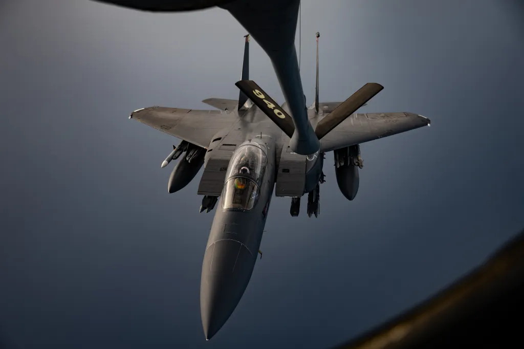 A US Air Force F-15E Strike Eagle is refueled mid-flight by a KC-135 Stratotanker.