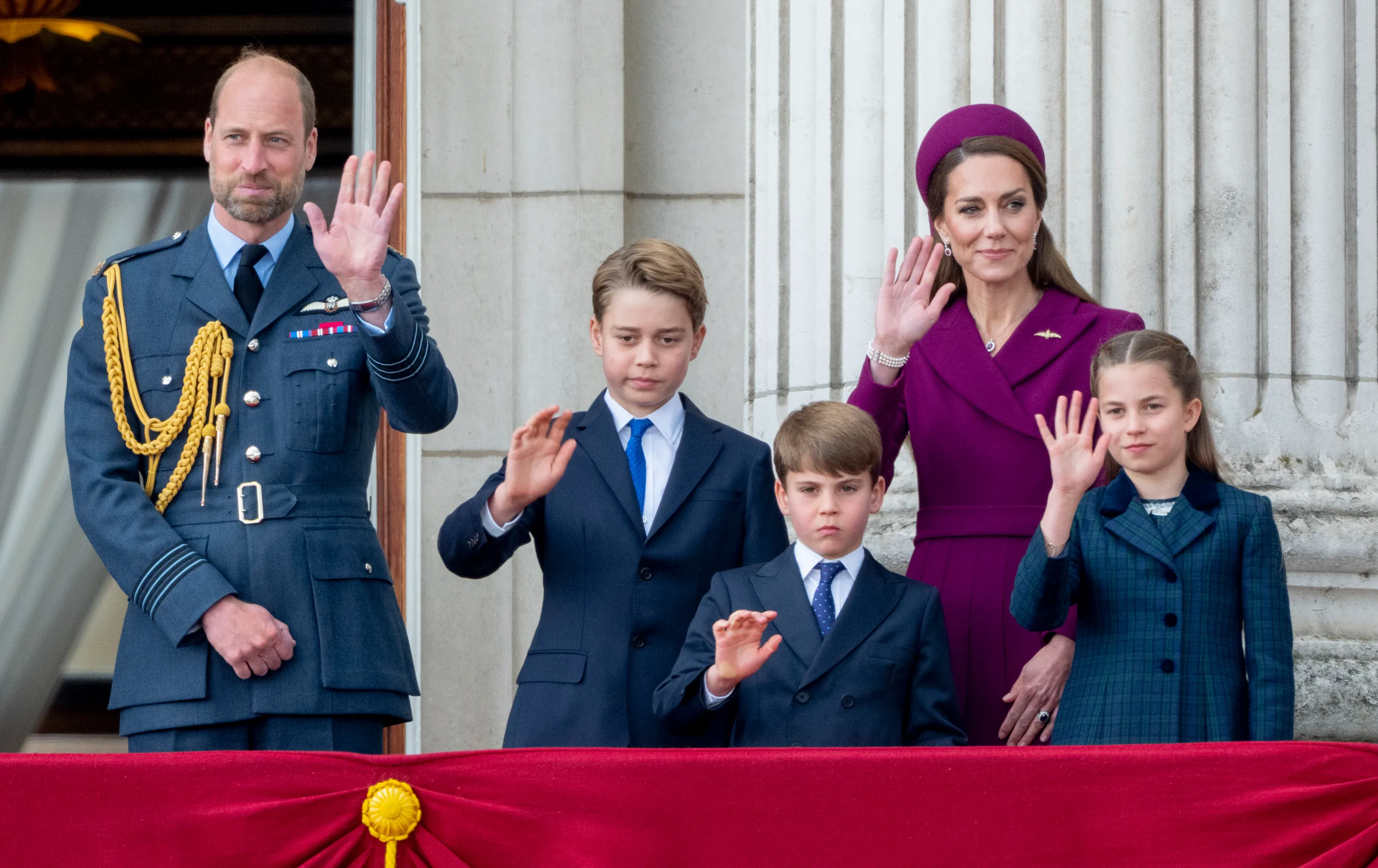 Prince William, Princess Catherine, Prince George, Prince Louis, and Princess Charlotte wave from the balcony of Buckingham Palace.