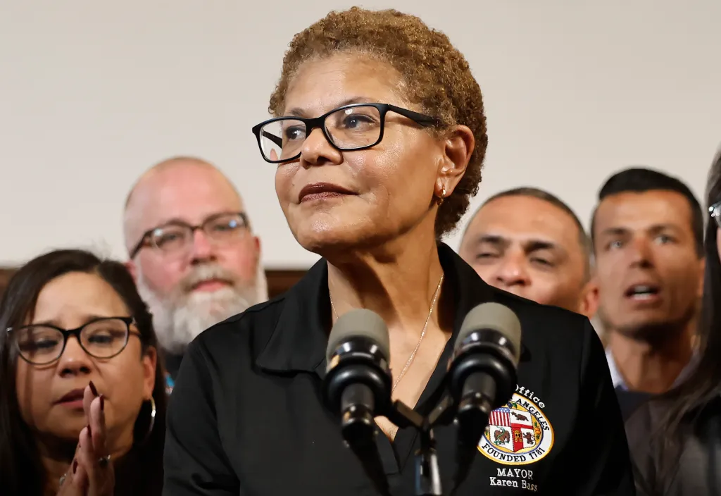Los Angeles Mayor Karen Bass speaking at a press conference with two microphones in front of her.