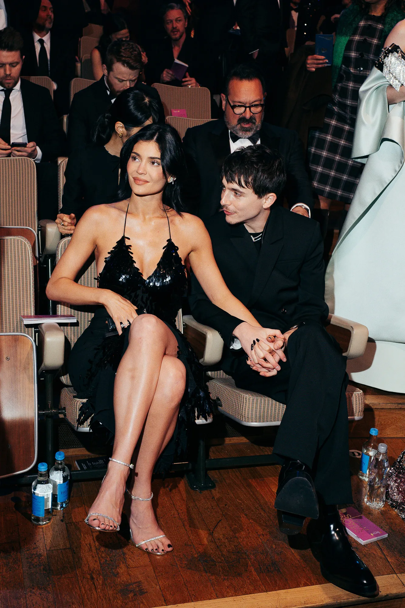 Kylie Jenner and Timothée Chalamet sitting together and holding hands at the EE BAFTA Film Awards 2025.