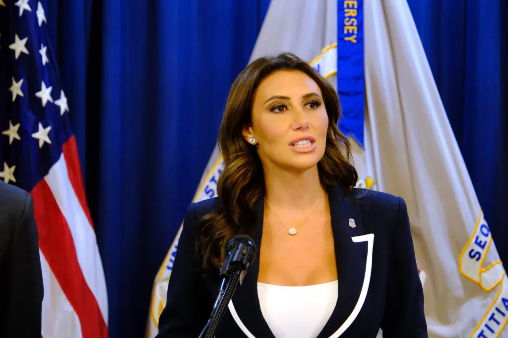 Acting U.S. Attorney Alina Habba speaking at a press conference.