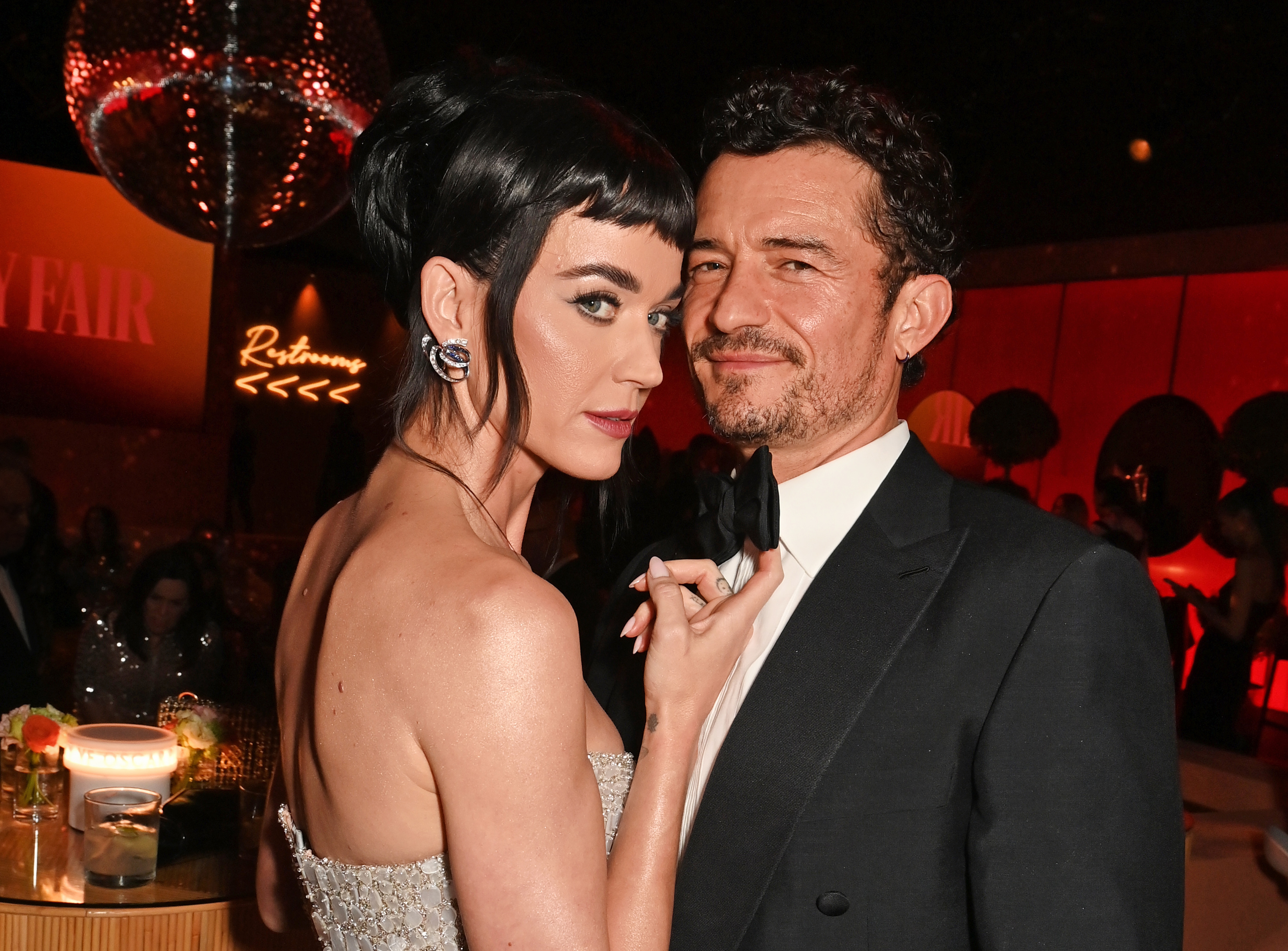 Katy Perry and Orlando Bloom pose at the 2025 Vanity Fair Oscar Party.