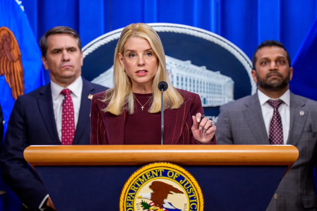 Deputy Attorney General Todd Blanche looks on as Pam Bondi speaks at a news conference at the Justice Department on Nov. 19, 2025. 