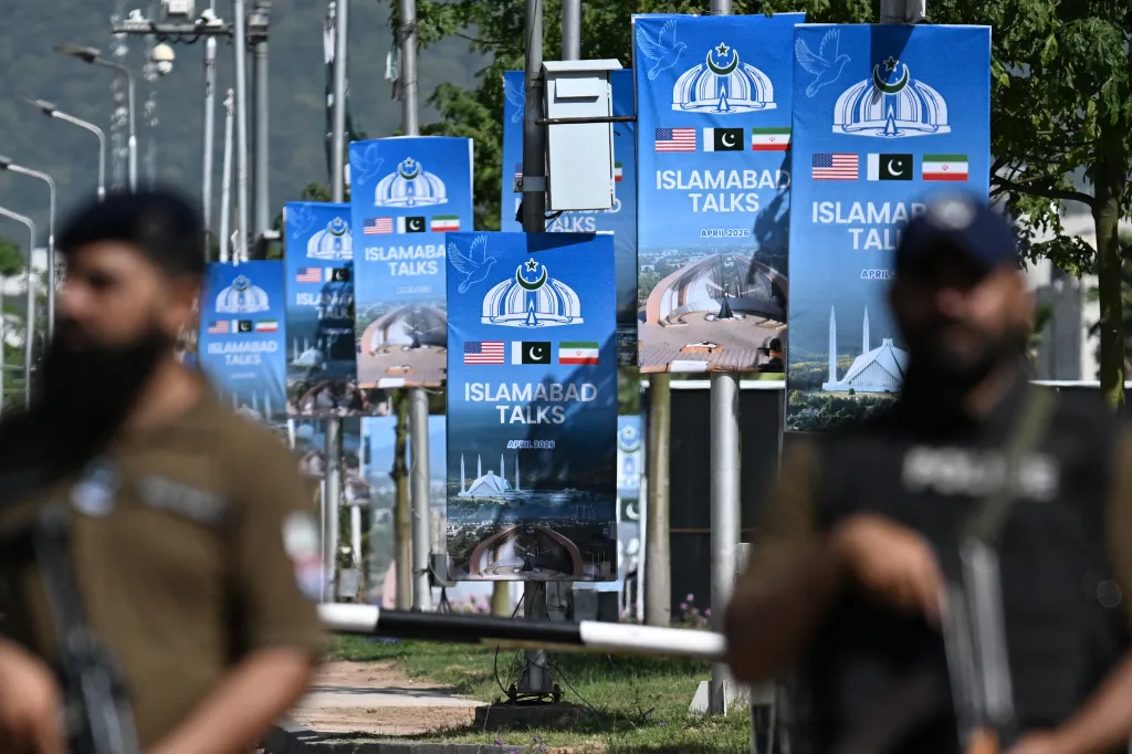 Security personnel stand guard near banners for the 