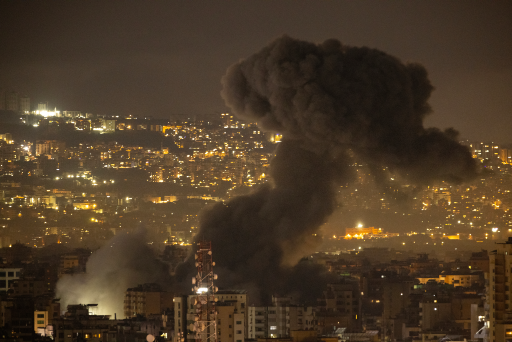 Nighttime shot of Beirut with smoke rising from an Israeli strike.