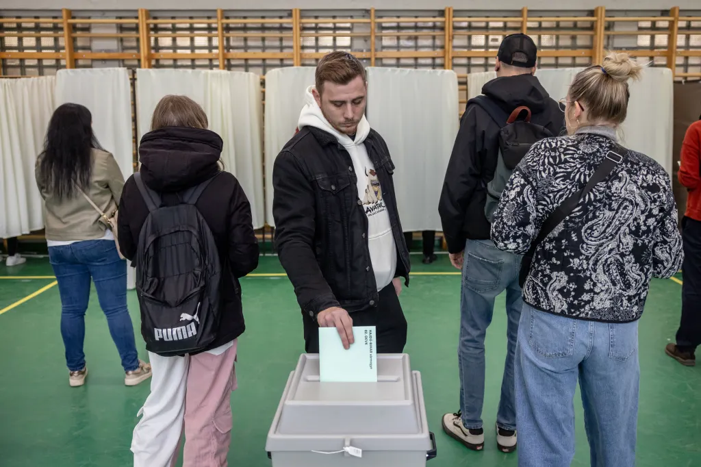 A man places his ballot into a ballot box at a polling station in Hungary.