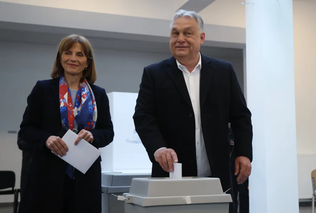 Hungarian Prime Minister Viktor Orban casts his ballot, accompanied by his wife Aniko Levai.