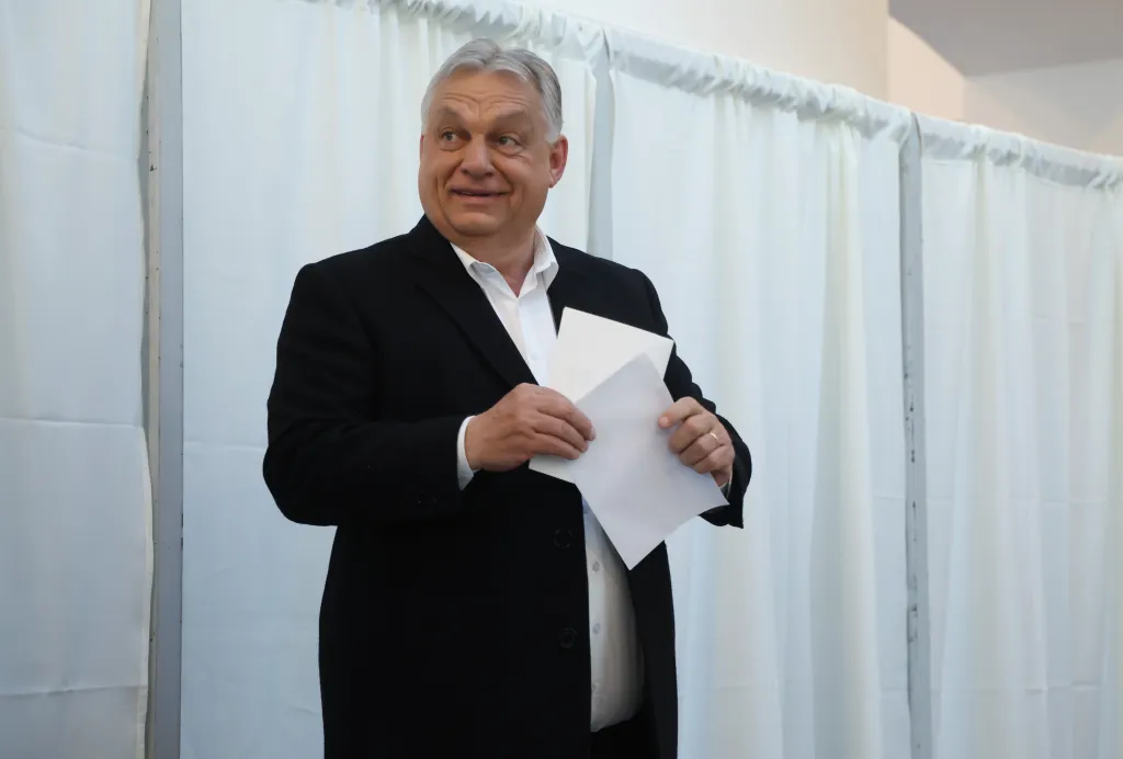 Hungarian Prime Minister Viktor Orban holding his ballot at a polling station.