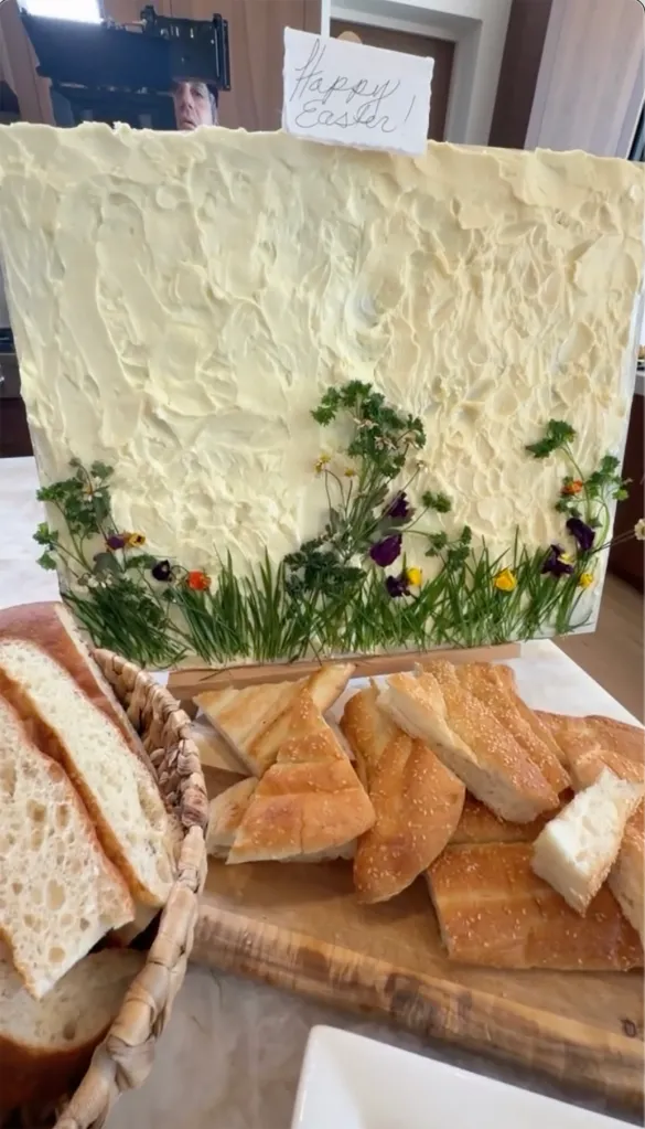 An Easter celebration spread with bread, flatbread, and a large butter sculpture of a spring landscape.
