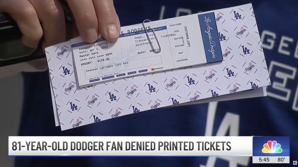 Hand holding a Dodgers paper ticket printed for 
