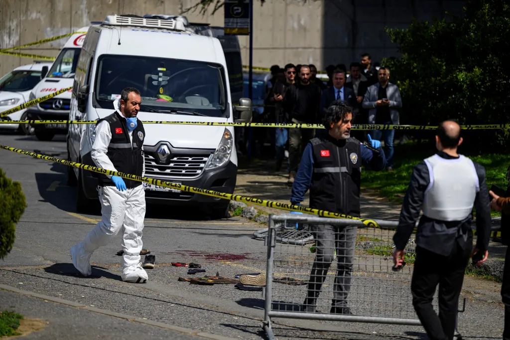 Police officials investigate the scene outside the Israeli Consulate in Istanbul after a shootout.