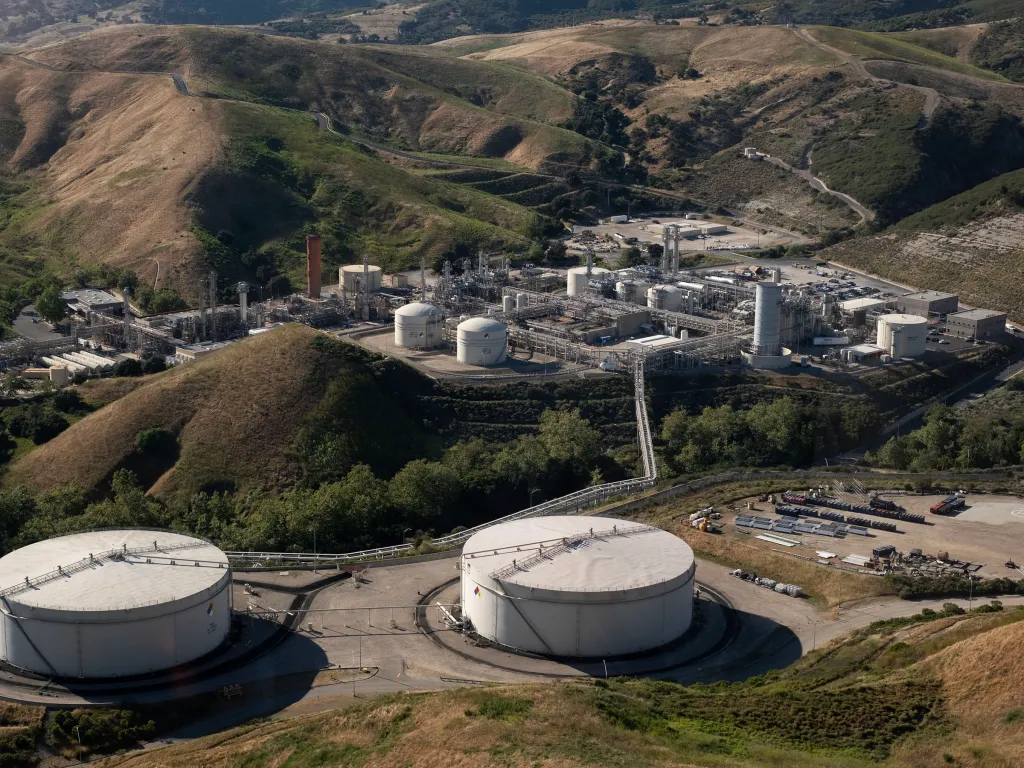 Aerial view of Sable Offshore's Las Flores Canyon facility, with hills and vegetation in the background.